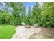 Inviting fire pit area with charming stone patio and comfortable seating, perfect for cozy outdoor gatherings at 516 Main St, Hiram, GA 30141