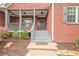 Welcoming entrance with gray steps and quaint porch, complemented by landscaped surroundings at 516 Main St, Hiram, GA 30141