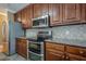 Gourmet kitchen boasting granite countertops, stainless steel appliances, and rich wood cabinetry at 516 Main St, Hiram, GA 30141