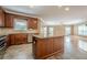 Open kitchen with island bar, stainless appliances, and seamless flow to living area at 516 Main St, Hiram, GA 30141