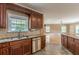 Eat in kitchen featuring stainless appliances, granite counters and view to living room at 516 Main St, Hiram, GA 30141