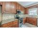 Modern kitchen featuring granite countertops, stainless appliances, and ample cabinets at 516 Main St, Hiram, GA 30141