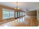 Expansive living room with hardwood floors, large windows, and French doors leading to outdoor space at 516 Main St, Hiram, GA 30141