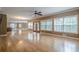 Open-concept living room features hardwood floors, large windows, and a ceiling fan at 516 Main St, Hiram, GA 30141