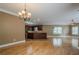 Open concept living room connecting to a kitchen with hardwood floors and an island at 516 Main St, Hiram, GA 30141