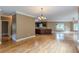 Open-concept living area with hardwood floors and a view of the modern kitchen at 516 Main St, Hiram, GA 30141