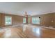 Spacious living room with hardwood floors, windows, and ceiling fan at 516 Main St, Hiram, GA 30141