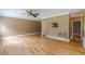 Inviting living room with gleaming hardwood floors, neutral walls, and a ceiling fan for added comfort at 516 Main St, Hiram, GA 30141