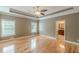 Bedroom features hardwood floors, ceiling fan, and en suite bathroom at 516 Main St, Hiram, GA 30141