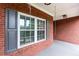 Detail of covered front porch with window and swing at 516 Main St, Hiram, GA 30141