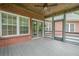 Relaxing screened porch overlooking brick facade and wooden floors at 516 Main St, Hiram, GA 30141