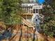 The back of the home shows a mulched backyard leading to a wooden staircase up to the house at 582 Lakeshore Ne Dr, Atlanta, GA 30307