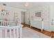 Cozy Bedroom featuring a crib, dresser, and decorative wallpaper at 582 Lakeshore Ne Dr, Atlanta, GA 30307