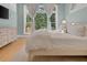 Bright bedroom featuring large windows, streaming sunlight and soft neutral tones at 582 Lakeshore Ne Dr, Atlanta, GA 30307