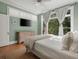 Relaxing bedroom featuring large windows, streaming sunlight and a ceiling fan at 582 Lakeshore Ne Dr, Atlanta, GA 30307