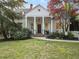 Inviting home exterior with a brick walkway leading to a classic columned front porch at 582 Lakeshore Ne Dr, Atlanta, GA 30307