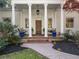 Detailed view of the home's elegant columned porch with brick accents and seating at 582 Lakeshore Ne Dr, Atlanta, GA 30307