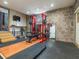 Spacious home gym featuring a stone wall and a weight rack at 582 Lakeshore Ne Dr, Atlanta, GA 30307