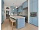 A well-appointed kitchen with light blue cabinets, stainless steel appliances and center island at 582 Lakeshore Ne Dr, Atlanta, GA 30307