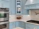Close-up of kitchen appliances, cabinets, and fixtures with white countertops and backsplash at 582 Lakeshore Ne Dr, Atlanta, GA 30307