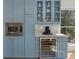 Kitchen with blue cabinets and stainless appliances, including wine cooler and microwave at 582 Lakeshore Ne Dr, Atlanta, GA 30307