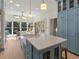 Bright kitchen with blue cabinets, a marble island, and a window overlooking the backyard at 582 Lakeshore Ne Dr, Atlanta, GA 30307
