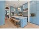 Bright kitchen boasts blue cabinets, stainless steel appliances, and a large island with bar seating at 582 Lakeshore Ne Dr, Atlanta, GA 30307