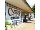 The Candler Park Market is shown with tables and chairs outside and signage with the business name at 582 Lakeshore Ne Dr, Atlanta, GA 30307