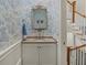 Charming powder room features granite countertop, and blue toile wallpaper at 582 Lakeshore Ne Dr, Atlanta, GA 30307