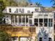 A large deck and screened-in porch highlight the back of this two-story home with skylights and tall windows at 582 Lakeshore Ne Dr, Atlanta, GA 30307