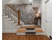 Beautiful staircase with stone wall and hardwood floors at 582 Lakeshore Ne Dr, Atlanta, GA 30307