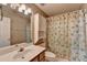 Well-lit bathroom featuring a vanity sink, a toilet, and shower with charming nautical-themed shower curtain at 1464 Yorktown Nw Dr, Lawrenceville, GA 30043