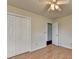 Comfortable bedroom with closet, hardwood floors, ceiling fan, and access to an additional room at 1464 Yorktown Nw Dr, Lawrenceville, GA 30043