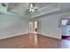 Bright primary bedroom featuring tray ceilings, wood floors, and French doors to another room at 1464 Yorktown Nw Dr, Lawrenceville, GA 30043