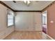 Bright bedroom with hardwood floors, ceiling fan and large window, offering a cozy atmosphere at 1464 Yorktown Nw Dr, Lawrenceville, GA 30043
