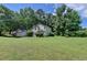 Charming traditional home with a two-car garage and lush surrounding trees at 1464 Yorktown Nw Dr, Lawrenceville, GA 30043