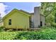 Exterior view of home featuring siding and a chimney nestled amongst greenery, providing backyard charm at 1464 Yorktown Nw Dr, Lawrenceville, GA 30043