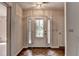 Foyer with decorative glass front door, sidelights, tile floor, and neutral paint at 1464 Yorktown Nw Dr, Lawrenceville, GA 30043