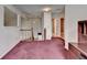 Upstairs hallway landing with carpeting, wooden railings, and access to several rooms at 1464 Yorktown Nw Dr, Lawrenceville, GA 30043
