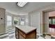 Bright kitchen featuring an island, decorative wallpaper, and several large windows overlooking the backyard at 1464 Yorktown Nw Dr, Lawrenceville, GA 30043