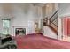 Spacious living room with a fireplace, high ceilings, and staircase at 1464 Yorktown Nw Dr, Lawrenceville, GA 30043