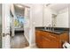 Modern bathroom with updated cabinets and mirror and view into the bedroom at 3300 Windy Ridge Se Pkwy # 718, Atlanta, GA 30339