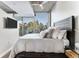Well-lit bedroom with a large window and an outside view and a modern style bed at 3300 Windy Ridge Se Pkwy # 718, Atlanta, GA 30339
