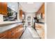 Galley kitchen featuring wood cabinets, gray countertops, stainless steel appliances, and a window with a nature view at 3300 Windy Ridge Se Pkwy # 718, Atlanta, GA 30339