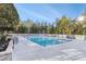 Community pool featuring lounge chairs, landscaping, and clear blue skies at 3300 Windy Ridge Se Pkwy # 718, Atlanta, GA 30339