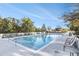 Community pool featuring lounge chairs, landscaping, and clear blue skies at 3300 Windy Ridge Se Pkwy # 718, Atlanta, GA 30339