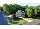 Aerial view of a beautiful two-story home with lush landscaping and a spacious driveway at 3510 Woodbury Creek Dr, Cumming, GA 30041