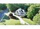 Aerial shot of a beautiful home with landscaped front yard, circular driveway, and lush green lawn at 3510 Woodbury Creek Dr, Cumming, GA 30041