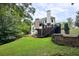 Backyard featuring a deck, patio, and professionally landscaped green space at 3510 Woodbury Creek Dr, Cumming, GA 30041