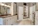 Bathroom featuring granite counters, built-in shelving, and a glass-enclosed shower at 3510 Woodbury Creek Dr, Cumming, GA 30041
